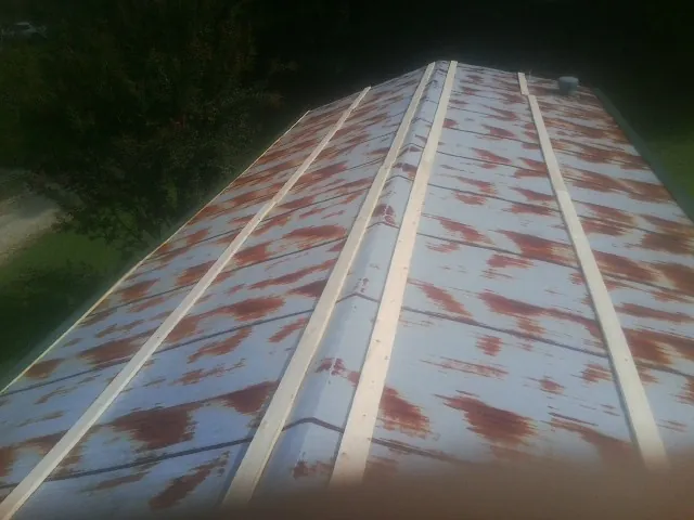 Rusted metal roof panels with new wood purlins before replacement — Storm Damage Roof Repair in Grass Valley by Roofing Brothers